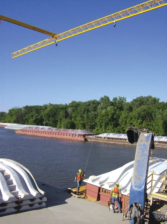 Barge with workers attached to overhead triangular truss