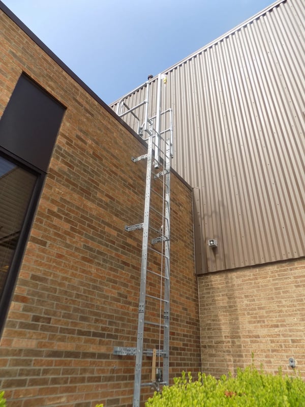 Fixed roof access ladder